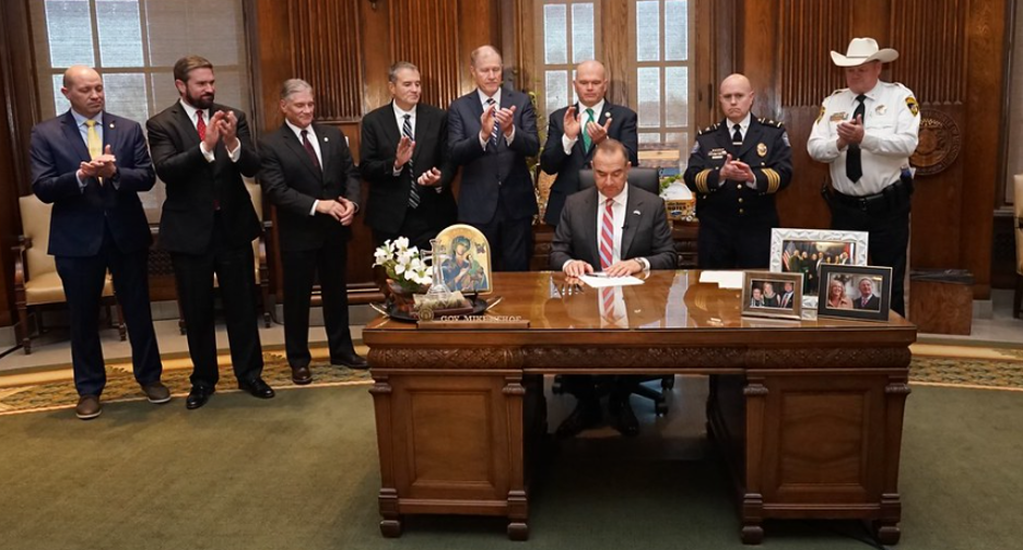 Governor Kehoe signing at his desk